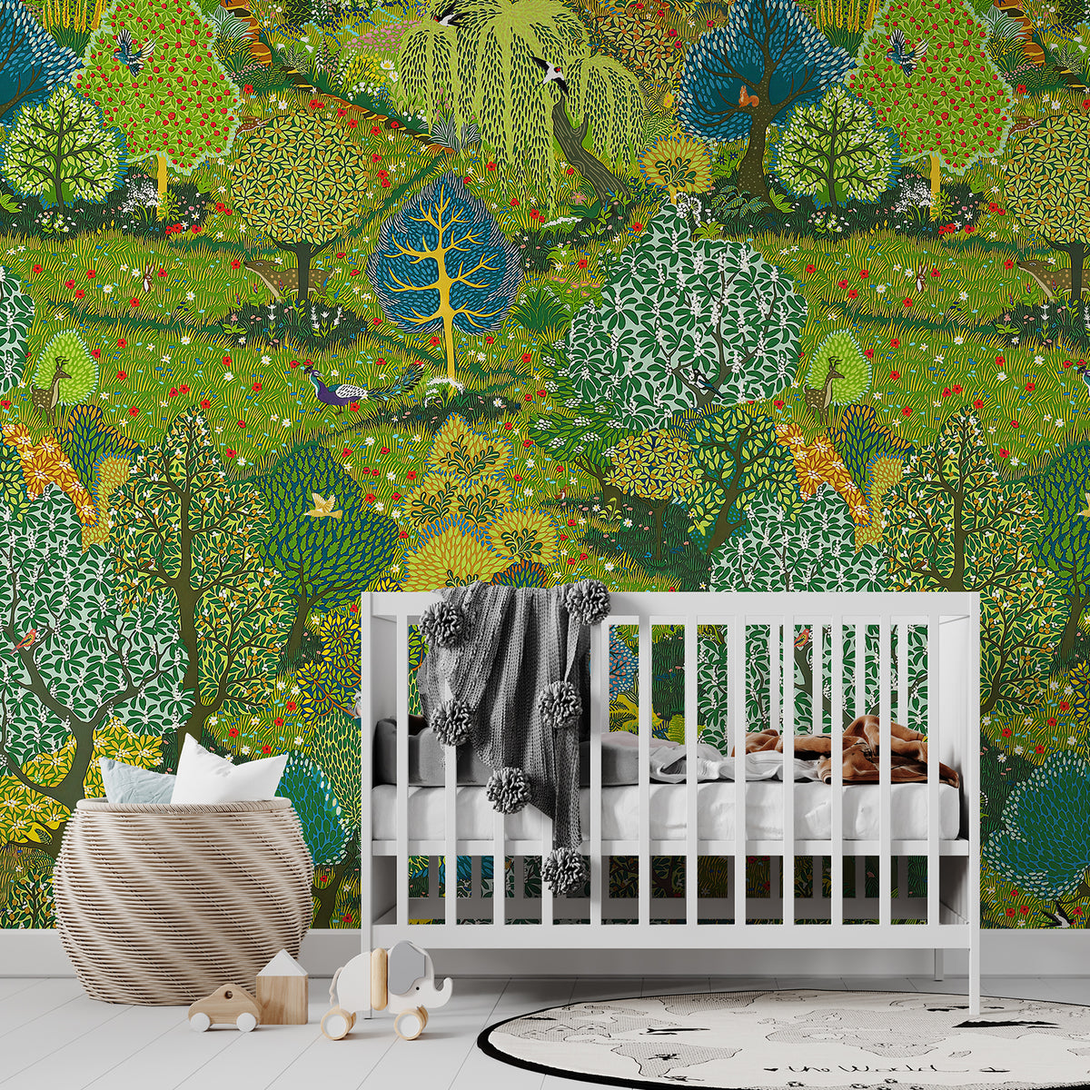 Green woodland garden wallpaper mural behind a white crib in a nursery