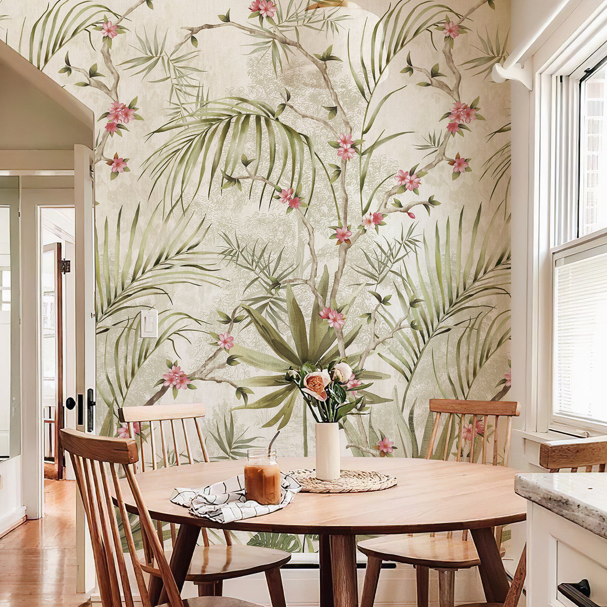 Soft green palm and pink blossom botanical wall mural in a bright dining room