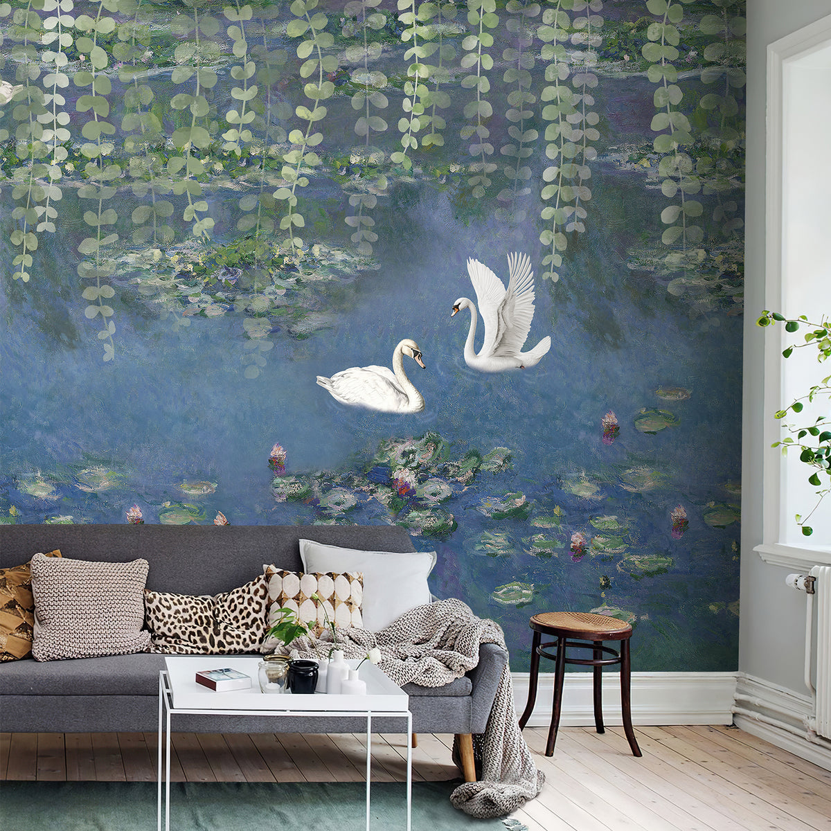 Swan pond wallpaper mural with lily pads and hanging foliage above a gray sofa