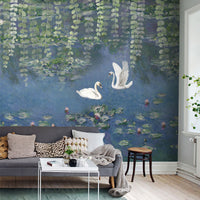 Swan pond wallpaper mural with lily pads and hanging foliage above a gray sofa