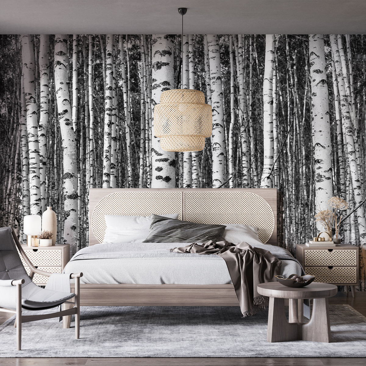 Black and white birch tree wall mural behind a modern minimalist bed