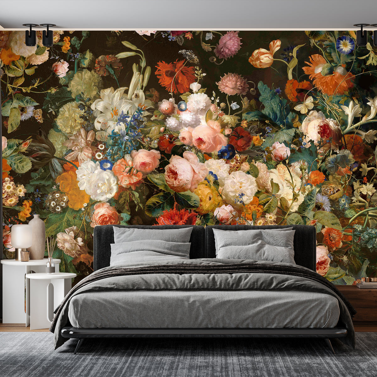 Dark botanical wallpaper mural with colorful oversized flowers behind a charcoal gray bed