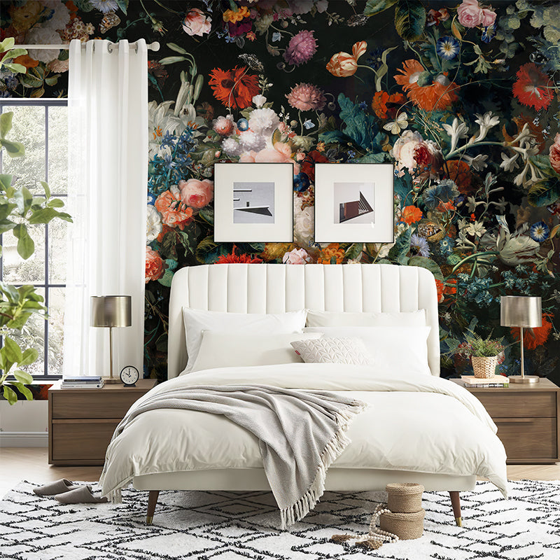 Dark floral wallpaper mural behind a white bed creating a romantic bedroom atmosphere