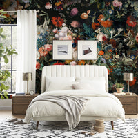 Dark floral wallpaper mural behind a white bed creating a romantic bedroom atmosphere