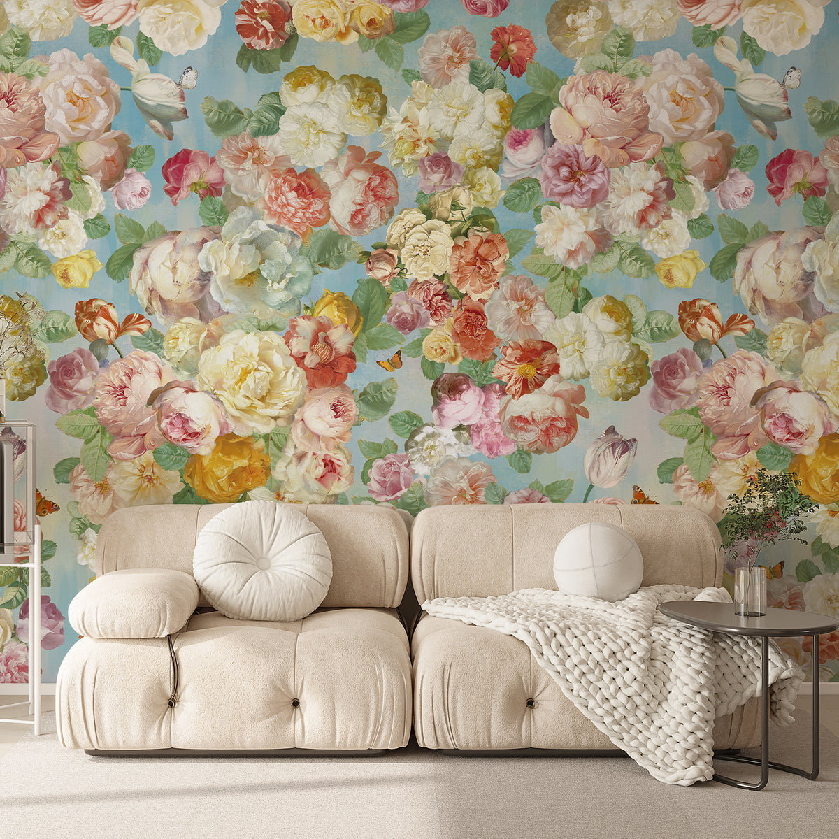Pastel floral wallpaper mural with pink and yellow blooms behind a cream sofa
