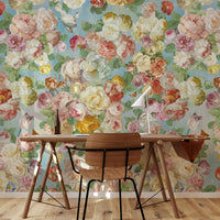 Vintage floral wallpaper mural with oversized blossoms behind a wooden dining table