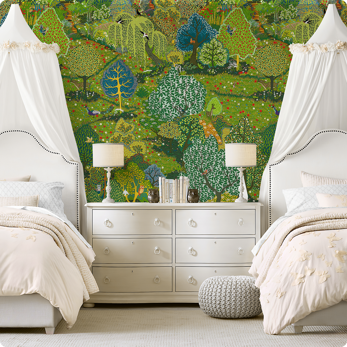 Green woodland wallpaper mural behind twin beds with white canopies