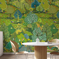 Illustrated green garden wallpaper mural behind a round dining table and wooden chairs
