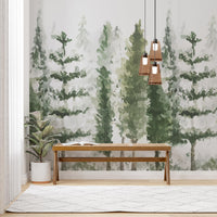 Watercolor pine forest wallpaper mural behind a wooden bench with woven pendant lights