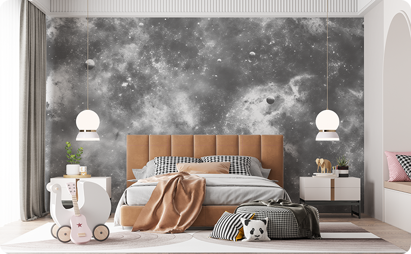 Gray galaxy wallpaper mural with stars, planets and nebula-like clouds behind a tan upholstered bed