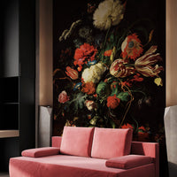 Moody vintage floral wall mural behind a pink sofa in a contemporary living room