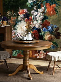 Vintage floral wall mural with oversized flowers behind a rustic wooden dining table